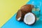 Coconut water, whole coconuts on a duo tone background. Coconut