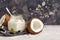 Coconut yogurt in a glass jar on a dark background, copy space,