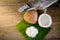 Coconuts and coconut flakes on banana leaf and coconut grater