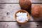 Coconuts and coconut oil on vintage wooden background