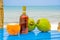 Coconuts and liquor bottle on table by the beach