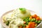 Cod fillet with a creamy cheese sauce, with mashed potato, peas and carrots