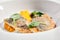 Cod fillet with pumpkin puree and spinach closeup. Seafood restaurant menu item. Delicious healthy food. Exquisite dish isolated o