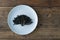 Codium fragile. Green algae in a ceramic dish on a wooden background