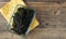 Codium fragile. Green algae in glass bowl on wooden background