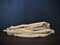 Codonopsis Root on brown wooden table with black background.