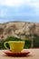 Coffe cup on the balcony overlooking Uchisar Mountain in Cappadocia