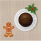 Coffe cup with Merry Christmas text and ginger bread man cookee Top view. Sweet Christmas breakfest.