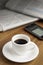 Coffe cup, smartphone and newspapers.