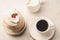 Coffe white cup with dessert and milk/Coffe white cup with dessert and milk on white marble background. Top view