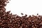 Coffee abstraction from fried brown beans. Many large premium coffee beans are located on the edge of the frame. coffee background