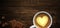 Coffee advertising design.White porcelain cup with coffee and a yellow heart in the middle on a wooden background. High detailed