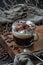 Coffee americano with milk foam and chocolate on a wooden board closeup. Low key photography