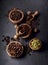 Coffee, anise, cardamon and nutmeg on black background