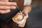 Coffee Art In Cup. Closeup Of Hands Making Latte Art