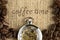 Coffee background of roasted coffee beans and pocket watch on gunny cloth background in concept of coffee time
