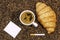 Coffee bean background with cup of fresh hot coffee and plate full of cookies