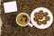 Coffee bean background with cup of fresh hot coffee and plate full of cookies