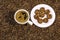 Coffee bean background with cup of fresh hot coffee and plate full of cookies