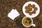 Coffee bean background with cup of fresh hot coffee and plate full of cookies