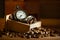 Coffee bean and pocket watch in manual grinder on table.