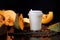 Coffee bean pumpkin spice latte nutrition recipie mock up. cut pumpkin coffee beans and white paper cup for coffee break