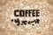 Coffee bean sign on a mosaic background with scattered coffee beans