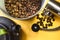 Coffee beans on bucket and water pot yellow background