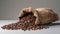 Coffee beans in a burlap bag on a gray background