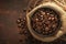 Coffee beans close up Burlap bag on wooden background, rich aroma