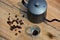 Coffee beans, coffee makers and small cups on a wooden table