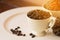 Coffee beans in cup on white plate with warm light effect , vintage stlye.