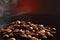 coffee beans on a dark background with a red highlight on the background, coffee beans close-up for a coffee shop