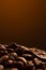 coffee beans on a dark background with a yellow highlight on the background, coffee beans close-up for a coffee shop
