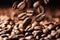 Coffee beans falling on pile, dark background with copy space, close up