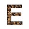 Coffee beans font. The letter E is cut out of paper on the background of roasted beans of excellent coffee. Set of decorative