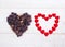 Coffee beans in heart shape on wooden background.