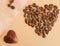 Coffee beans laid out in the shape of a heart on a beige background. Love for coffee.