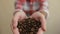 Coffee beans - man showing medium roasted coffee beans handful and scatter coffee beans.hands pouring coffee