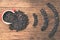 Coffee beans in red cup on old wooden table with copyspace. Coffee beans are arranged in the symbol wifi