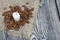 Coffee beans on rough linen and candle stub. On a surface of brushed pine boards painted black and white