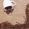 Coffee beans on sackcloth white cup