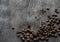 Coffee beans scattered on the gray background top view