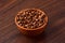 Coffee bens bowl on wooden background