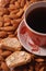 Coffee with biscotti on almond background