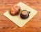 Coffee in black ceramic cup and croissant on glass saucer