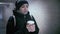 Coffee Bliss in Winter's Embrace: Woman's Serene Walk through the Underground, Sipping Warmth