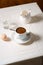 Coffee, boiled egg, milk and glass of water on linen tablecloth, breakfast