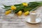 Coffee break with bouquet of yellow tulips