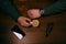 Coffee break. Man hand keep a cup of coffee on a wooden table. Phone and glasses. Business situation.